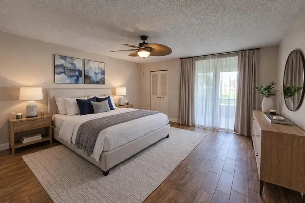 a bedroom with a large bed and a chandelier