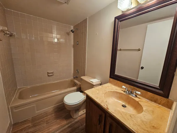 a bathroom with a sink toilet tub and shower