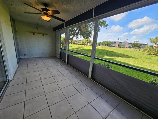 an empty room with floor to ceiling windows and stairs