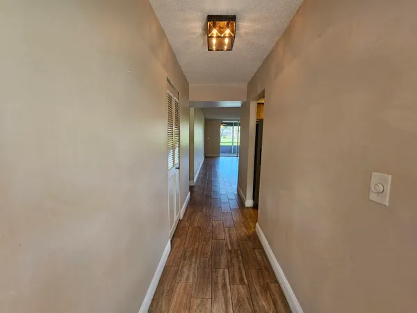 a view of a hallway with wooden floor