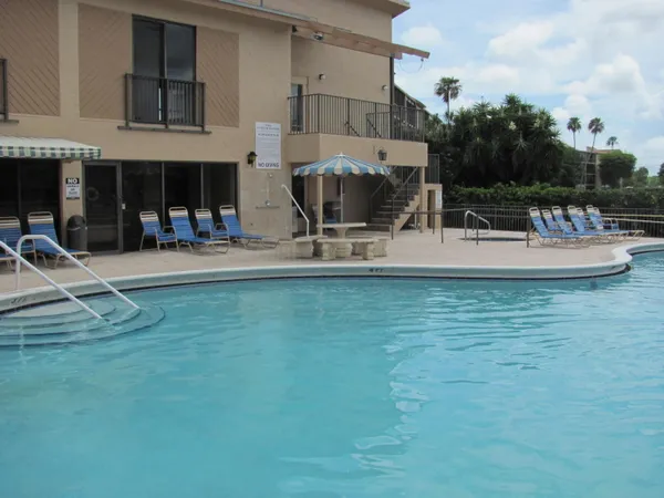 a view of a swimming pool with sitting area