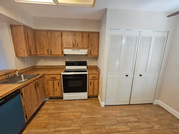 a kitchen with a stove top oven sink and cabinets