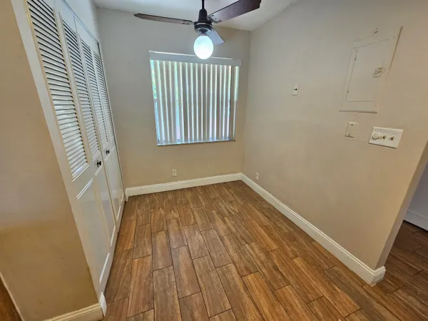 wooden floor in an empty room with a window