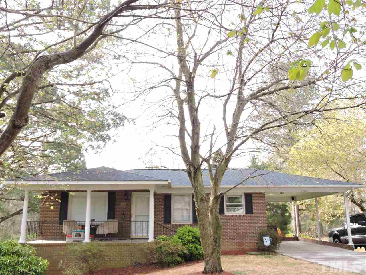 1104 Ridge Road Roxboro, NC 27573 - Photo 1 of 15 front view of a house with a tree