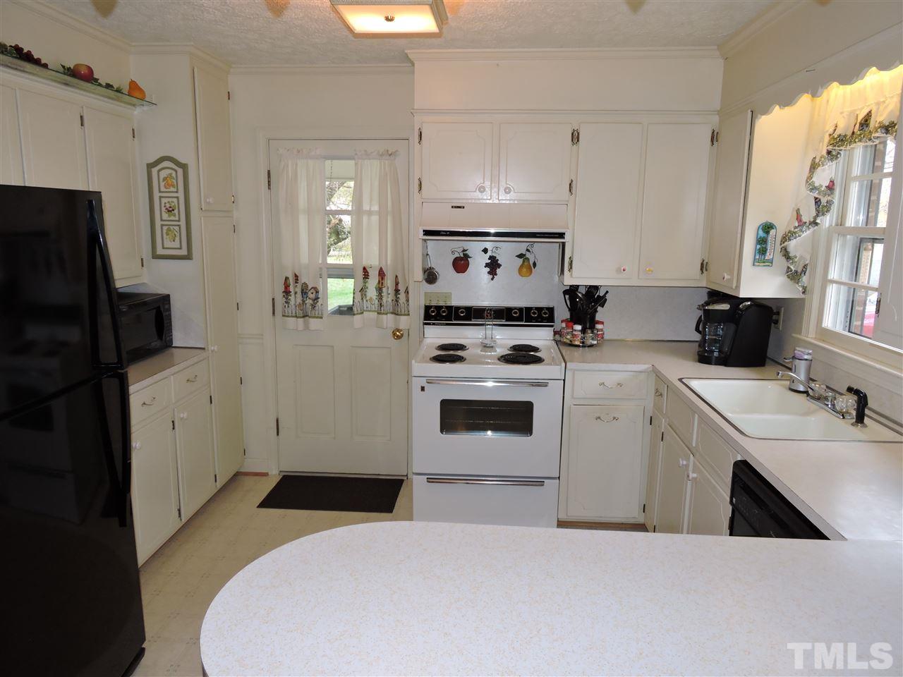 1104 Ridge Road Roxboro, NC 27573 - Photo 3 of 15 a kitchen with a sink a stove and refrigerator