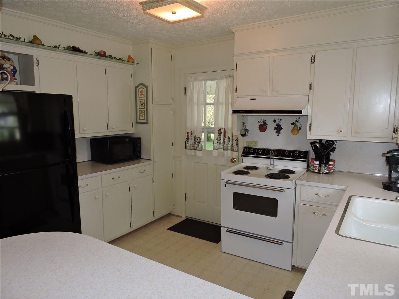 1104 Ridge Road Roxboro, NC 27573 - Photo 6 of 15 a kitchen with a stove and a refrigerator