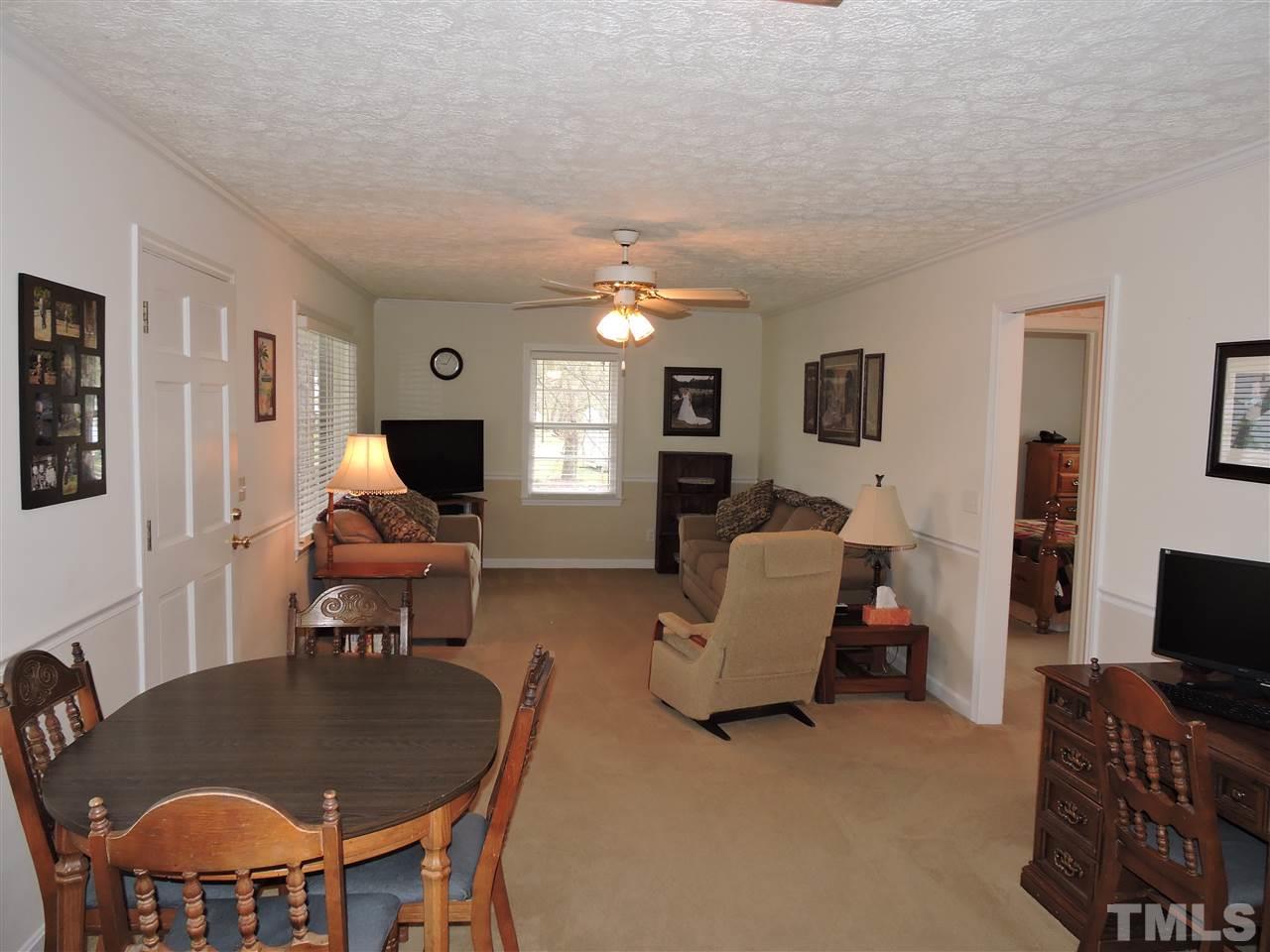 1104 Ridge Road Roxboro, NC 27573 - Photo 7 of 15 a living room with furniture a flat screen tv and a dining table