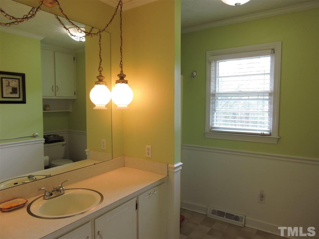 1104 Ridge Road Roxboro, NC 27573 - Photo 10 of 15 a bathroom with a sink and a mirror