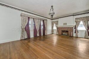 2000 South Polk Street Amarillo, TX 79109 - Photo 6 of 12 a view of empty room with wooden floor and fireplace