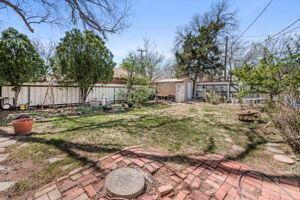 2000 South Polk Street Amarillo, TX 79109 - Photo 8 of 12 a view of a backyard with large trees and wooden fence