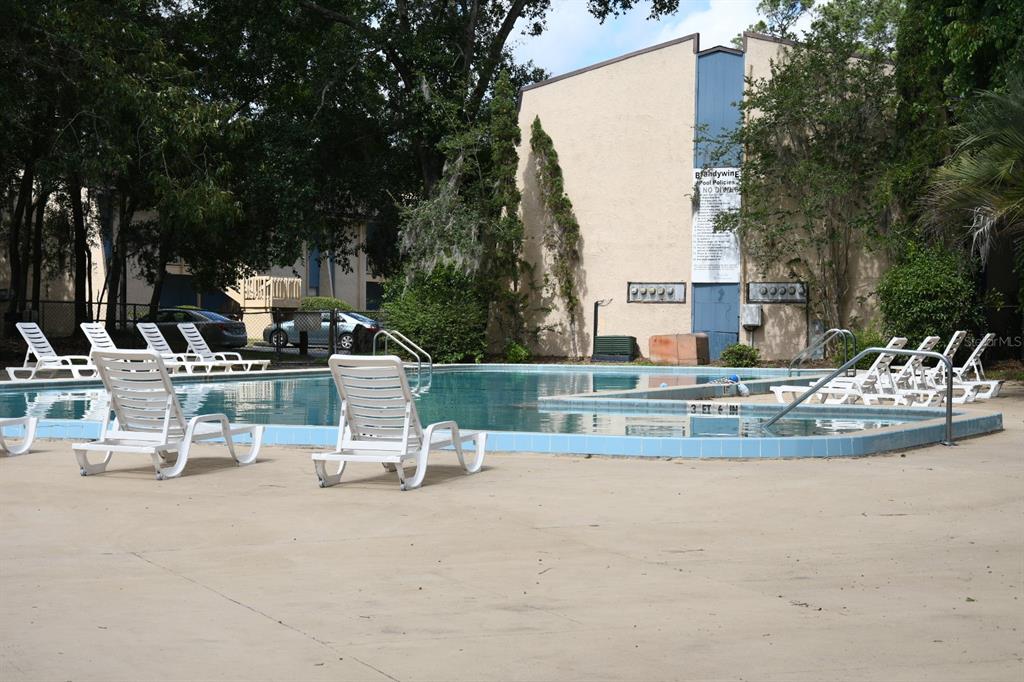 2811 Southwest Archer Road, Unit Y217 Gainesville, FL 32608 - Photo 11 of 11 an outdoor space with patio and white umbrellas