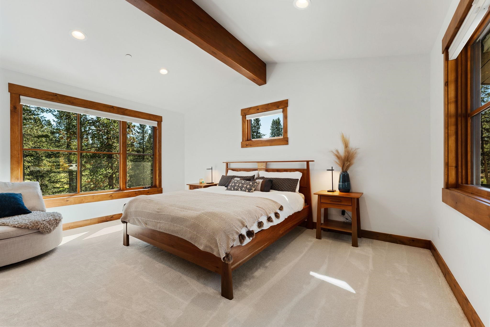 11791 Ghirard Road Truckee, CA 96161 - Photo 17 of 27 a spacious bedroom with a bed and a couch