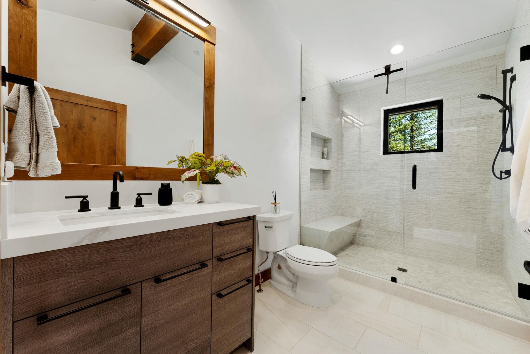 11791 Ghirard Road Truckee, CA 96161 - Photo 21 of 27 a bathroom with a sink a toilet a mirror and shower