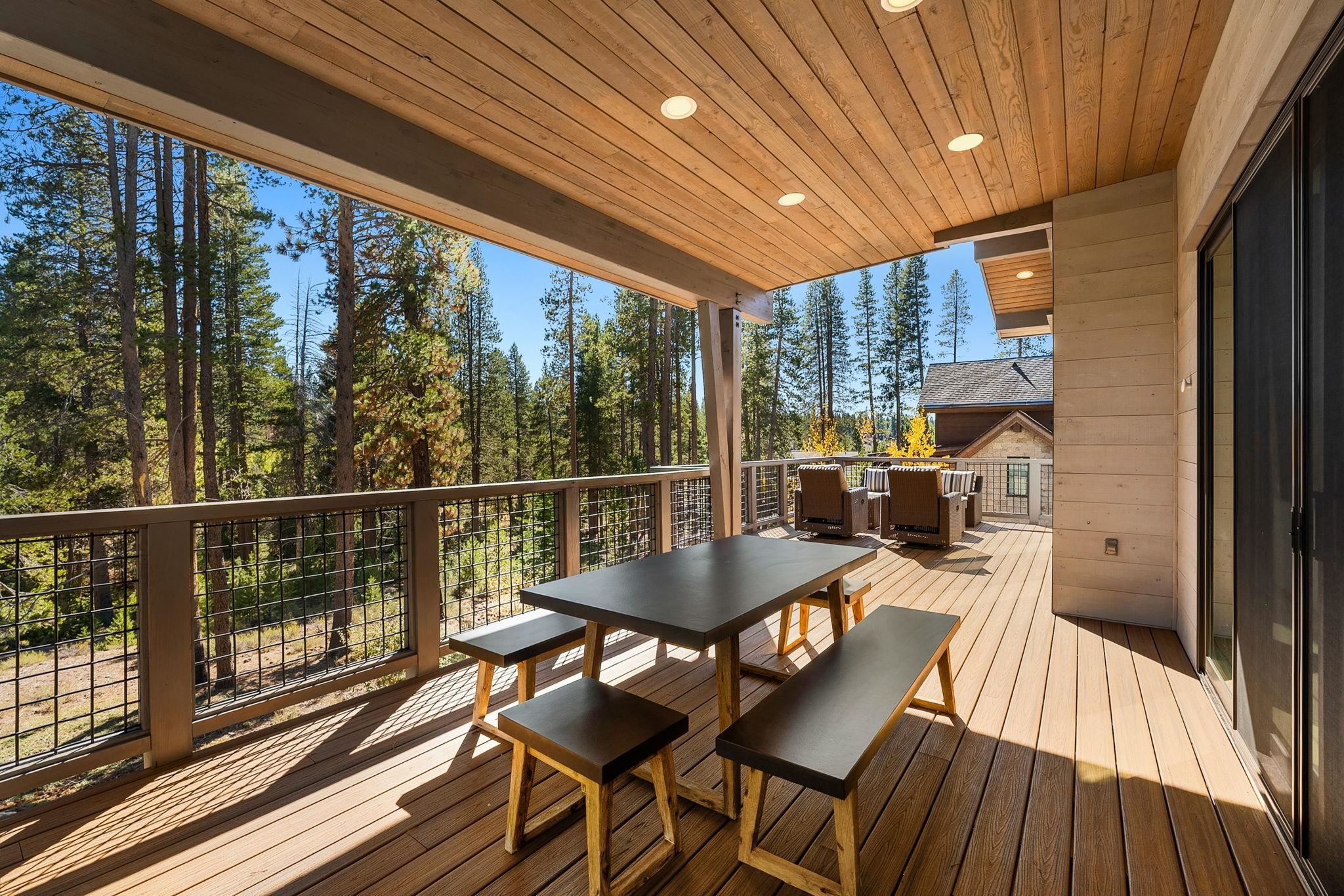 11791 Ghirard Road Truckee, CA 96161 - Photo 25 of 27 a view of a balcony with a dining table and chairs with wooden floor