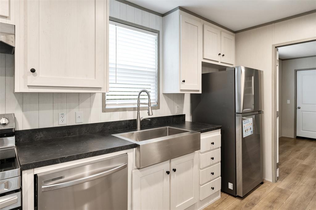 125 Neches Mabank, TX 75156 - Photo 12 of 23 a kitchen with granite countertop a refrigerator sink and cabinets