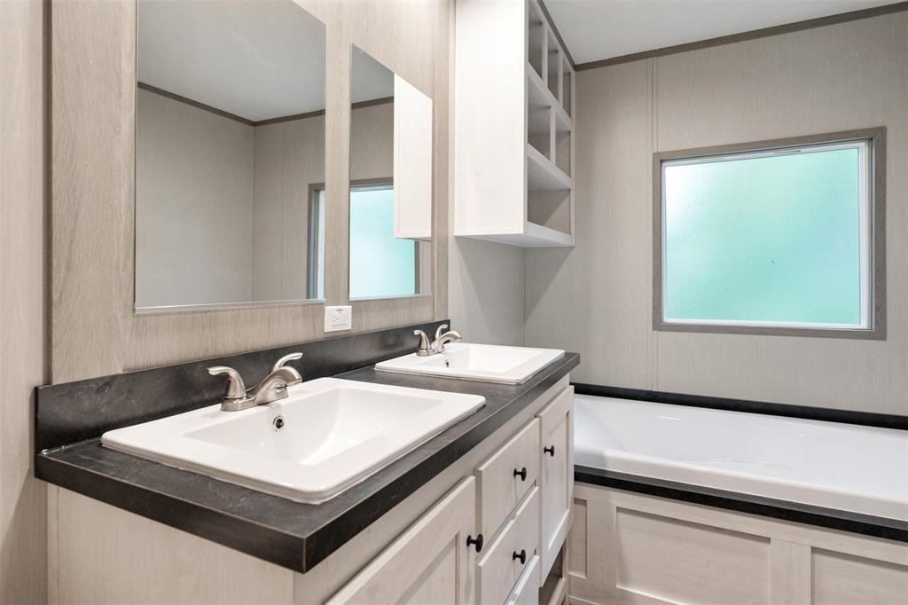 125 Neches Mabank, TX 75156 - Photo 16 of 23 a bathroom with a sink a mirror and a window
