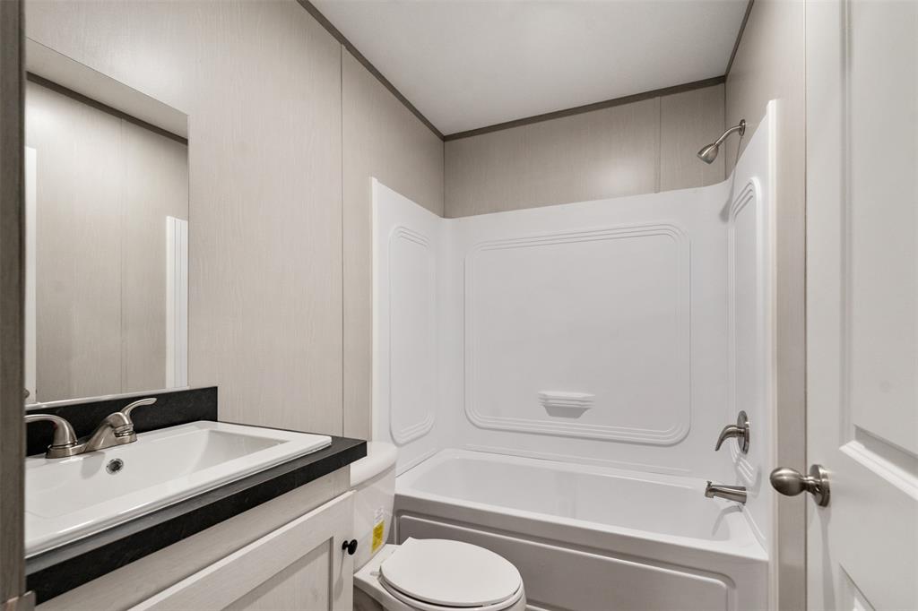 125 Neches Mabank, TX 75156 - Photo 19 of 23 a bathroom with a sink a toilet and a bathtub