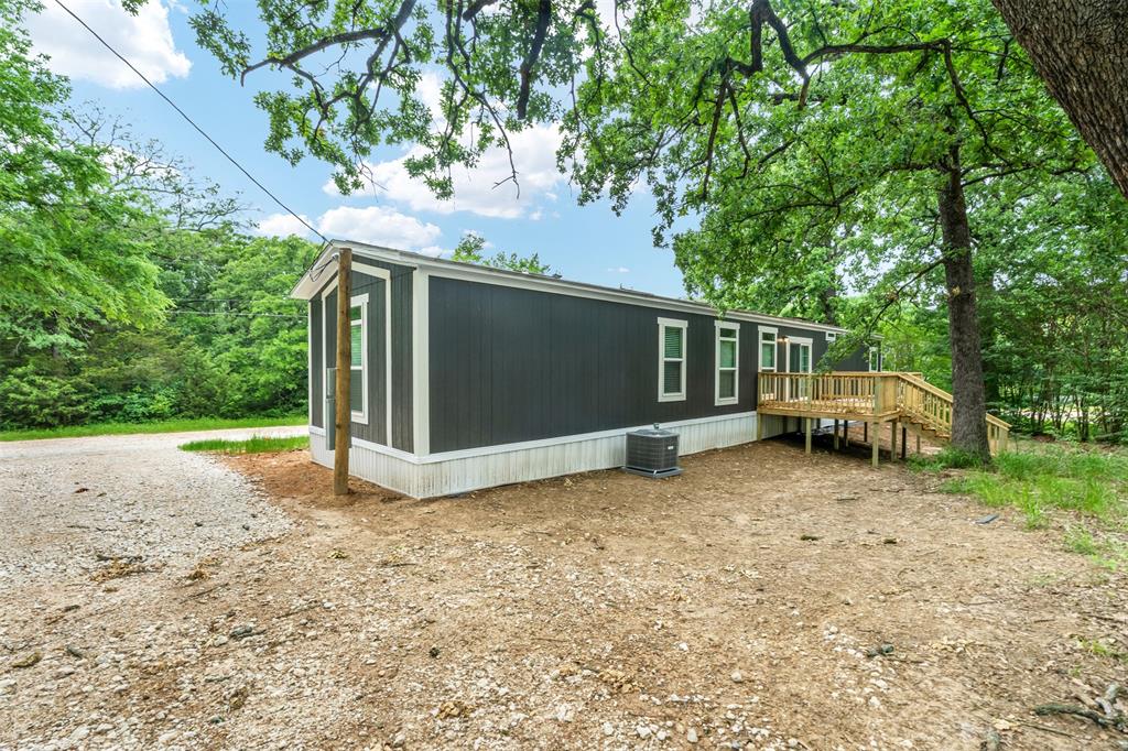 125 Neches Mabank, TX 75156 - Photo 21 of 23 a view of a house with a large tree and a yard