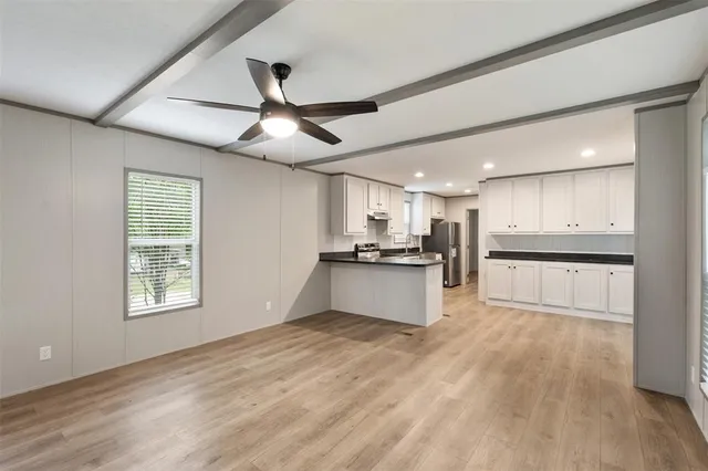 a view of kitchen with refrigerator and window