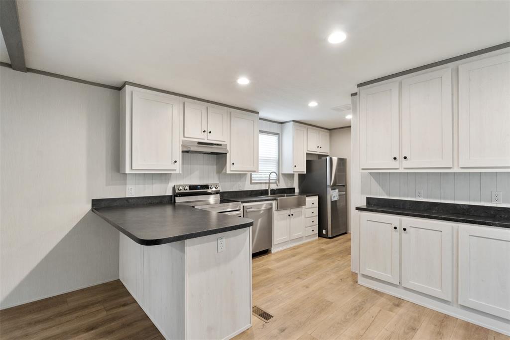 125 Neches Mabank, TX 75156 - Photo 9 of 23 a kitchen with white cabinets appliances and sink