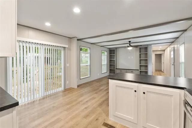 a kitchen with granite countertop a sink and cabinets