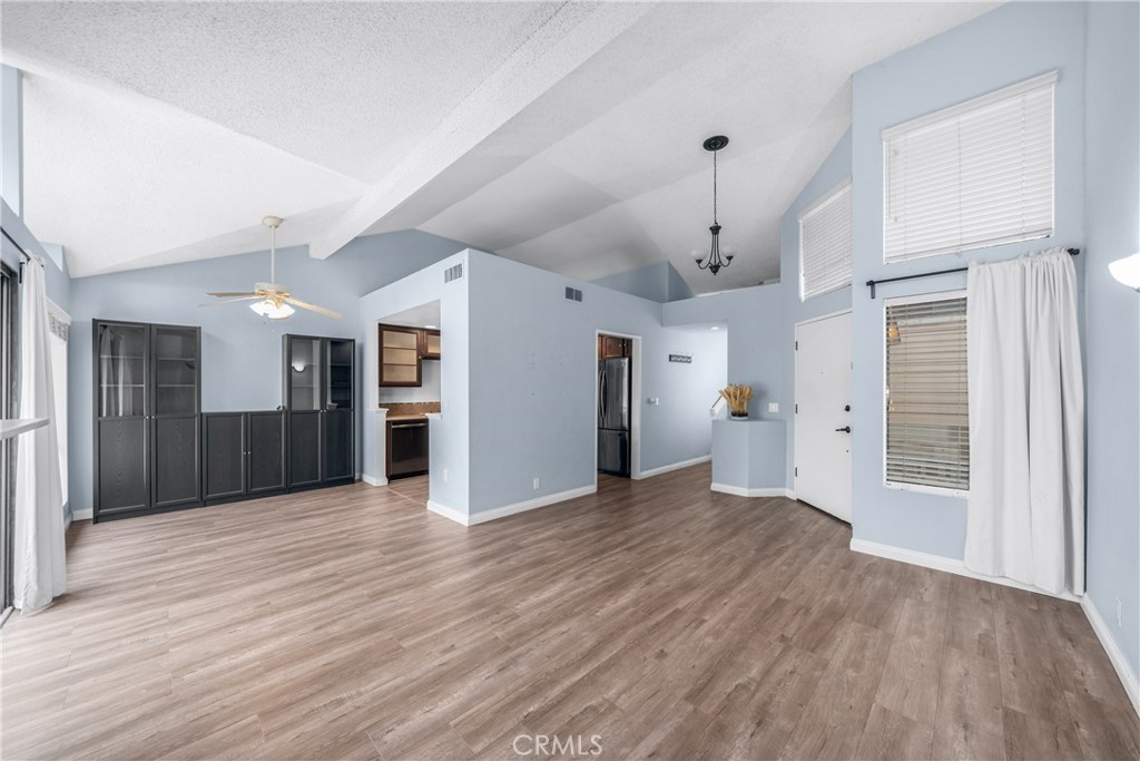 4900 North Grand Avenue, Unit 104 Covina, CA 91724 - Photo 14 of 27 a view of a hallway with wooden floor and entryway