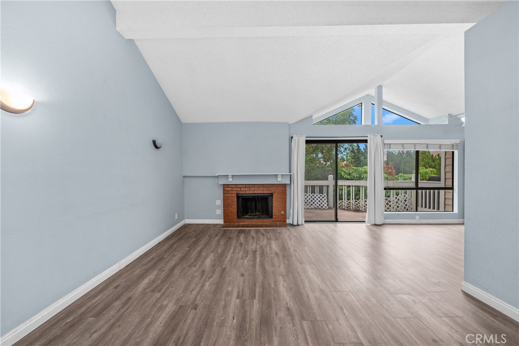 4900 North Grand Avenue, Unit 104 Covina, CA 91724 - Photo 16 of 27 a view of an empty room with wooden floor and a window