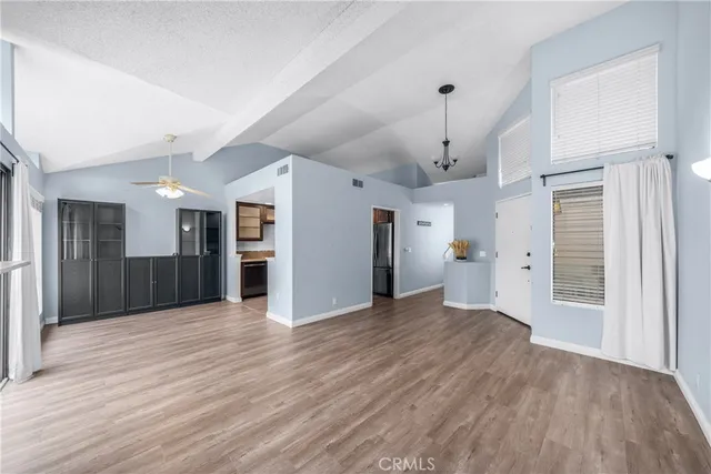 a view of a hallway with wooden floor and entryway