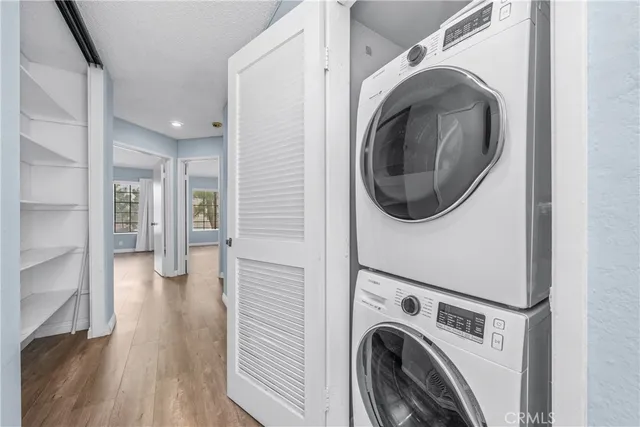 a view of a hallway with washer and dryer