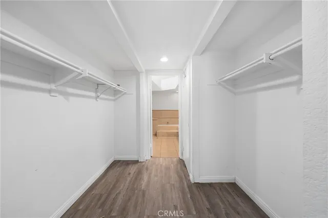 a view of a room with wooden floor and white walls