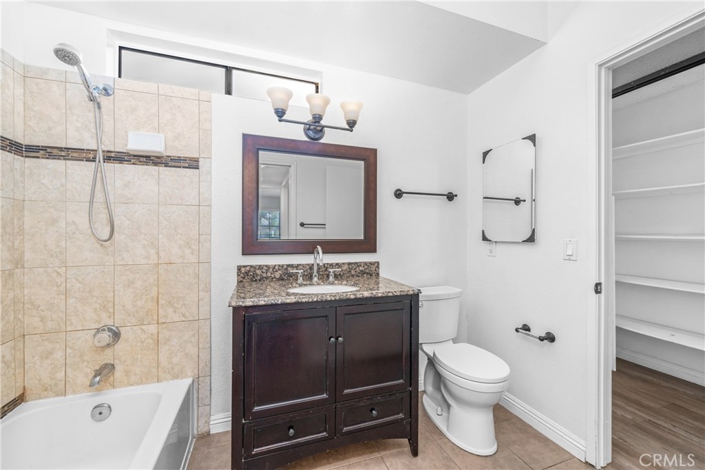 4900 North Grand Avenue, Unit 104 Covina, CA 91724 - Photo 26 of 27 a bathroom with a sink a toilet and shower
