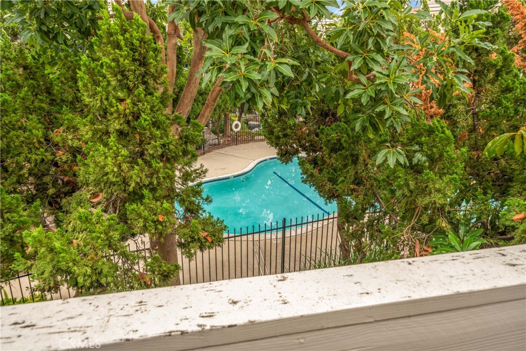 4900 North Grand Avenue, Unit 104 Covina, CA 91724 - Photo 5 of 27 a balcony with a tree