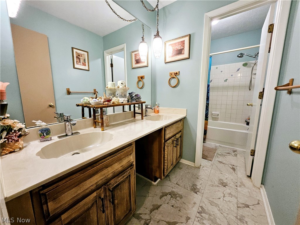 16551 Drake Road Strongsville, OH 44136 - Photo 30 of 50 Full bathroom on the 2nd floor featuring vanity with cabinet space, double sink, door to private toilet, and shower/bath