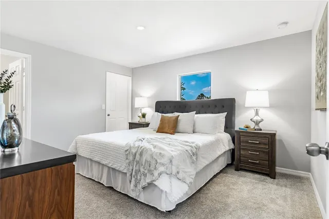 a bedroom with a bed and a dresser