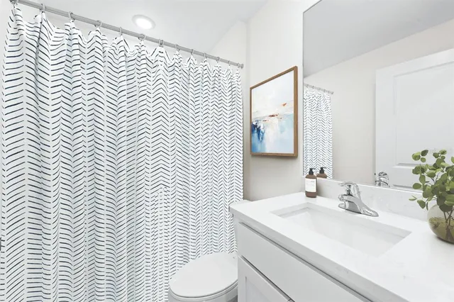 a bathroom with a sink a toilet and mirror