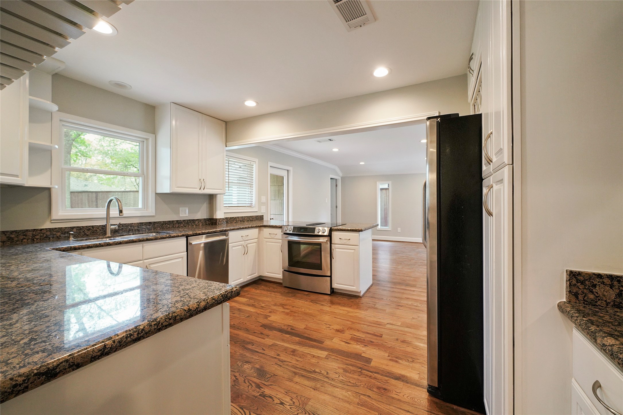 1229 Timbergrove Lane Houston, TX 77008 - Photo 11 of 30 a large kitchen with granite countertop a large counter top stainless steel appliances and windows