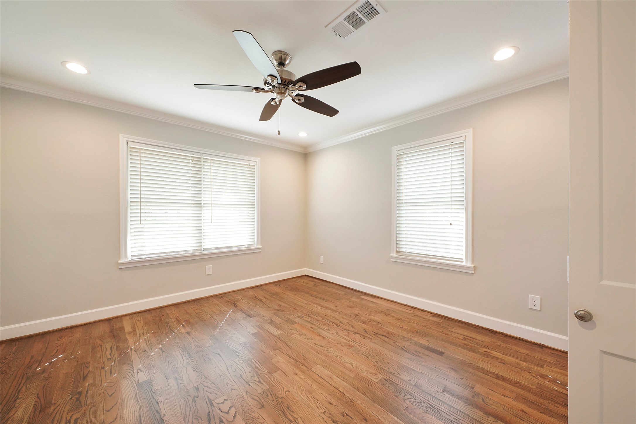 1229 Timbergrove Lane Houston, TX 77008 - Photo 20 of 30 a view of an empty room with wooden floor and a window