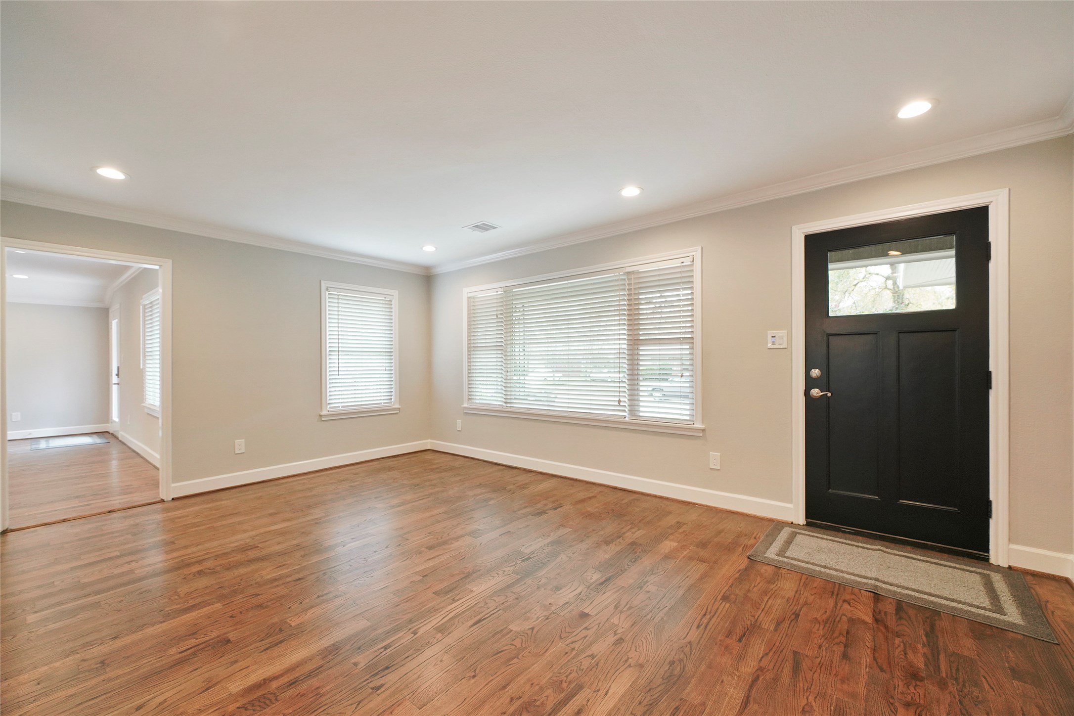 1229 Timbergrove Lane Houston, TX 77008 - Photo 2 of 30 an empty room with wooden floor and windows