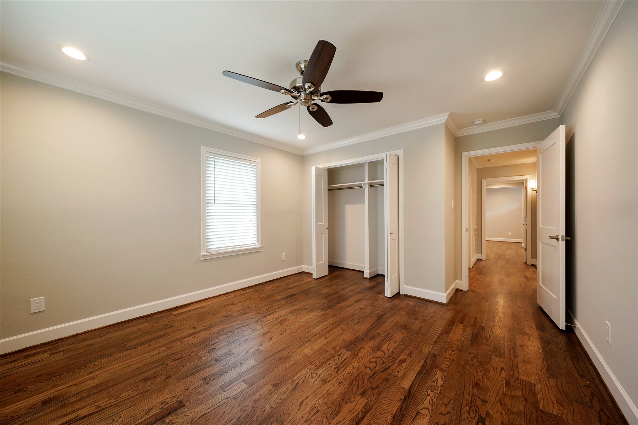 1229 Timbergrove Lane Houston, TX 77008 - Photo 21 of 30 a view of an empty room with wooden floor and a ceiling fan