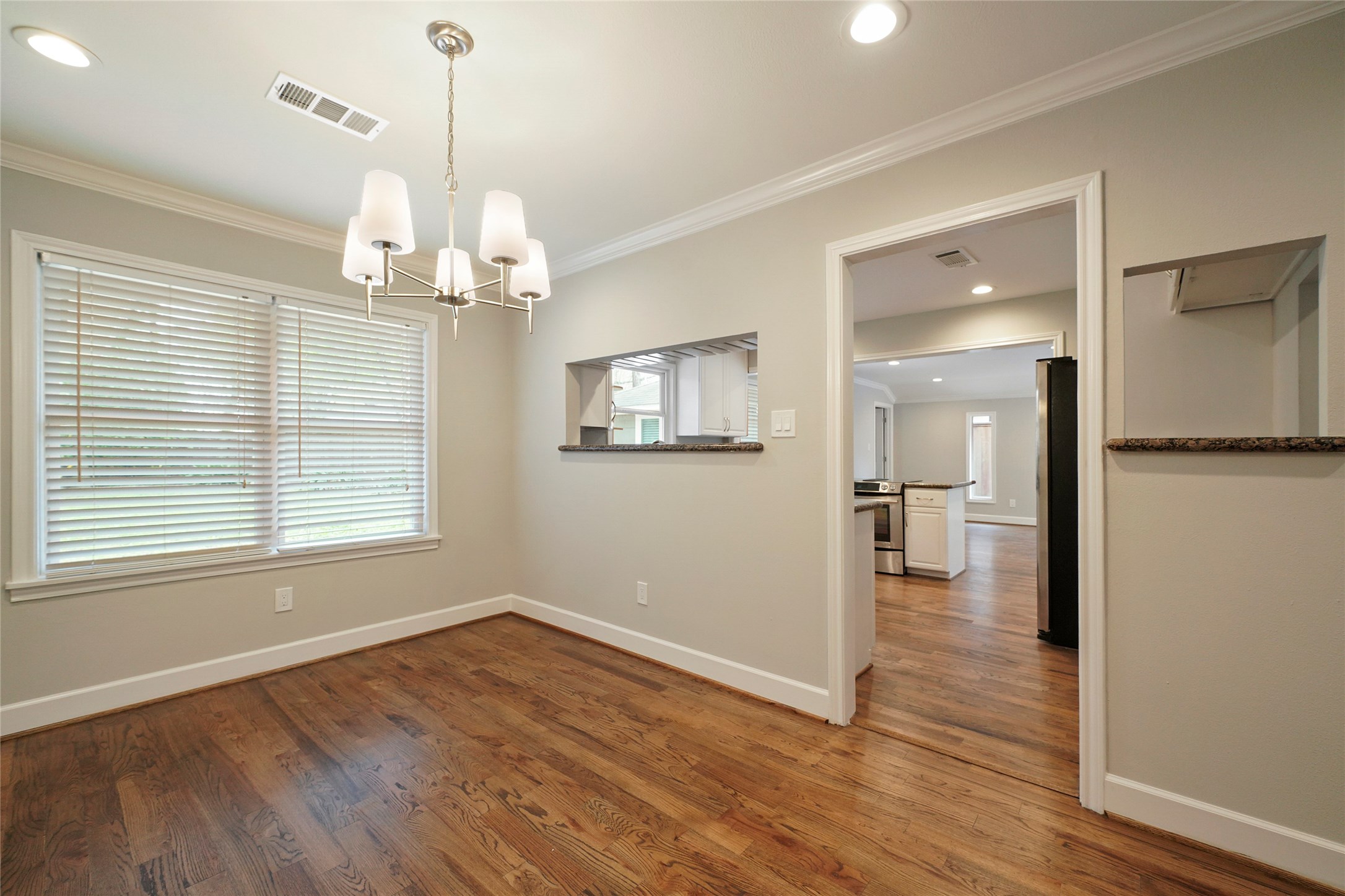 1229 Timbergrove Lane Houston, TX 77008 - Photo 8 of 30 a view of a room with wooden floor chandelier and windows