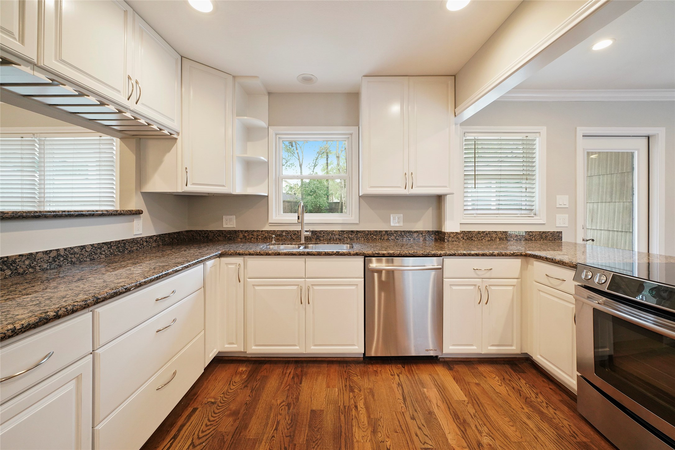 1229 Timbergrove Lane Houston, TX 77008 - Photo 9 of 30 a white kitchen with granite countertop stainless steel appliances a sink and cabinets