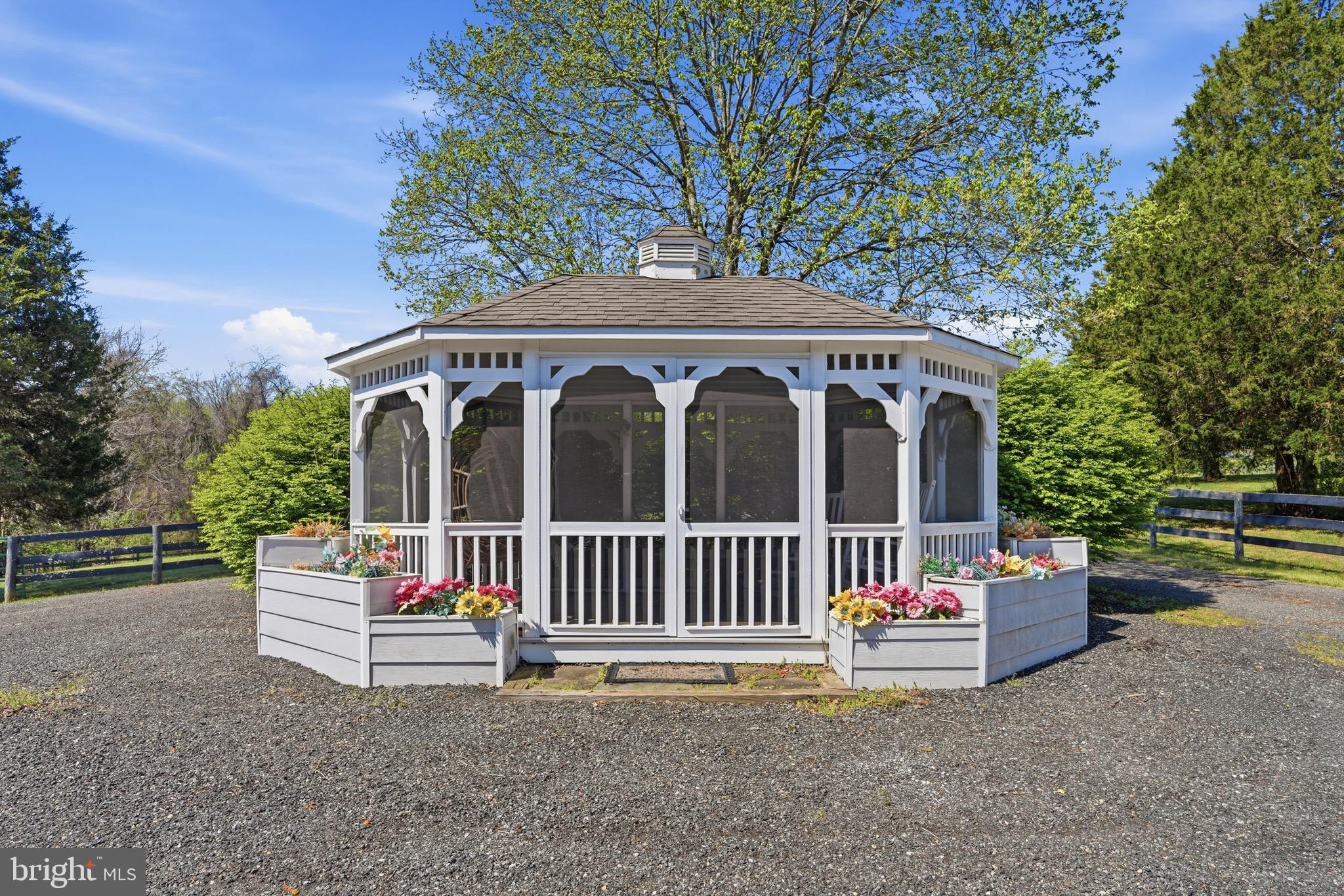 9571 Foxville Road Warrenton, VA 20186 - Photo 10 of 20 a front view of a house with a garden