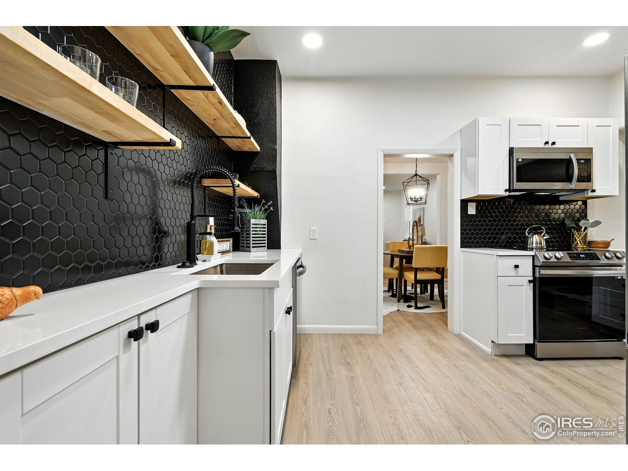24149 County Road 70 Eaton, CO 80615 - Photo 14 of 40 a kitchen with a sink cabinets and wooden floor