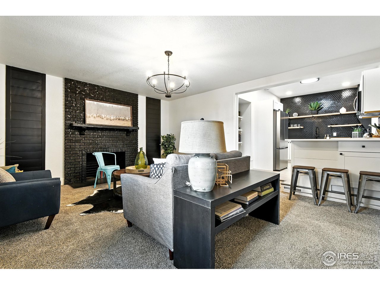 24149 County Road 70 Eaton, CO 80615 - Photo 16 of 40 a living room with furniture a fireplace and a flat screen tv