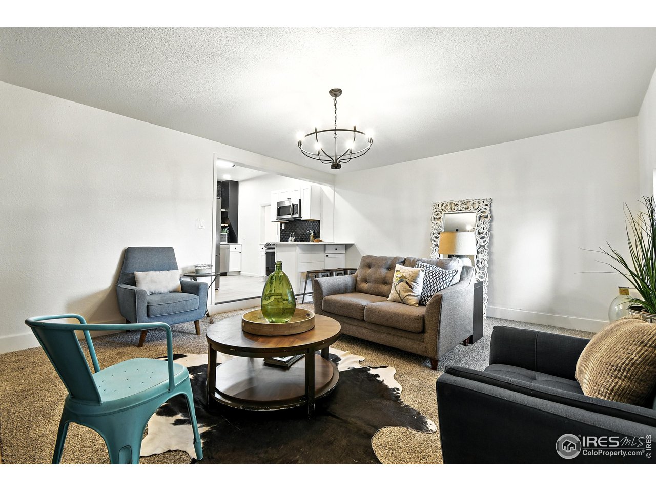 24149 County Road 70 Eaton, CO 80615 - Photo 17 of 40 a living room with fireplace furniture and a chandelier