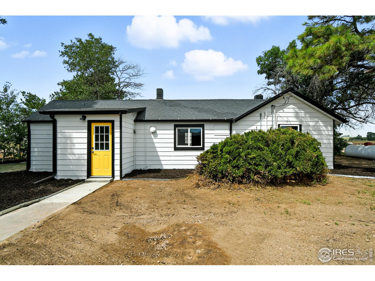 24149 County Road 70 Eaton, CO 80615 - Photo 32 of 40 a front view of a house with a garden