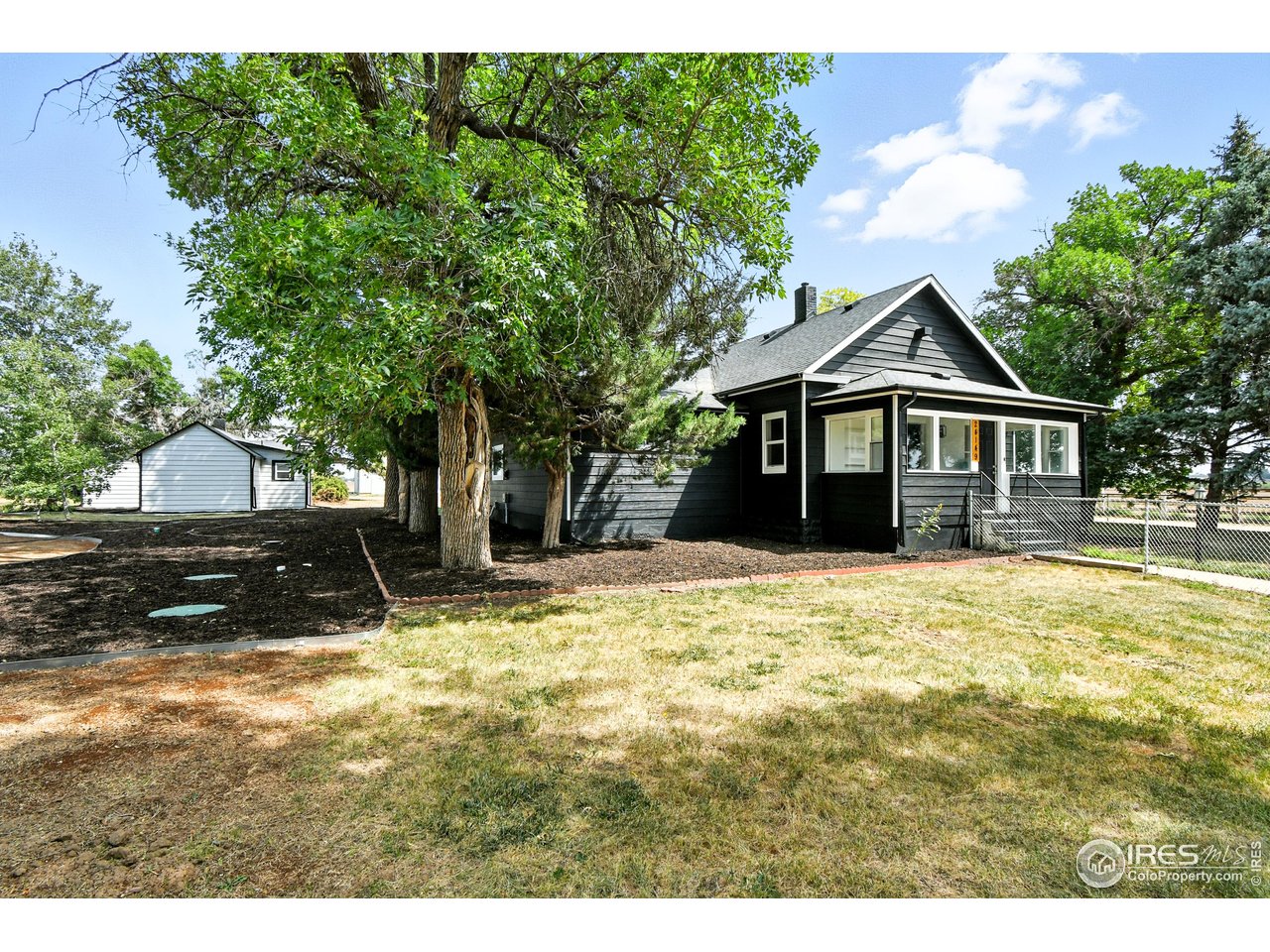 24149 County Road 70 Eaton, CO 80615 - Photo 5 of 40 a front view of a house with a yard