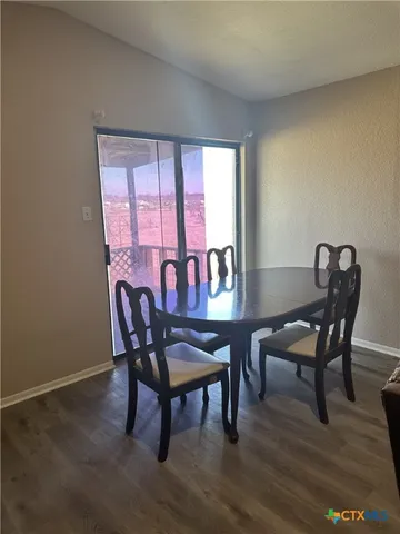 a living room with furniture a lamp and a wooden floor