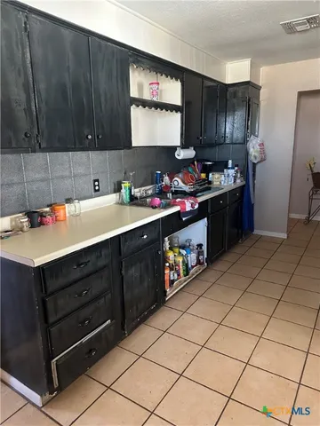 a room with furniture a flat screen tv and a refrigerator