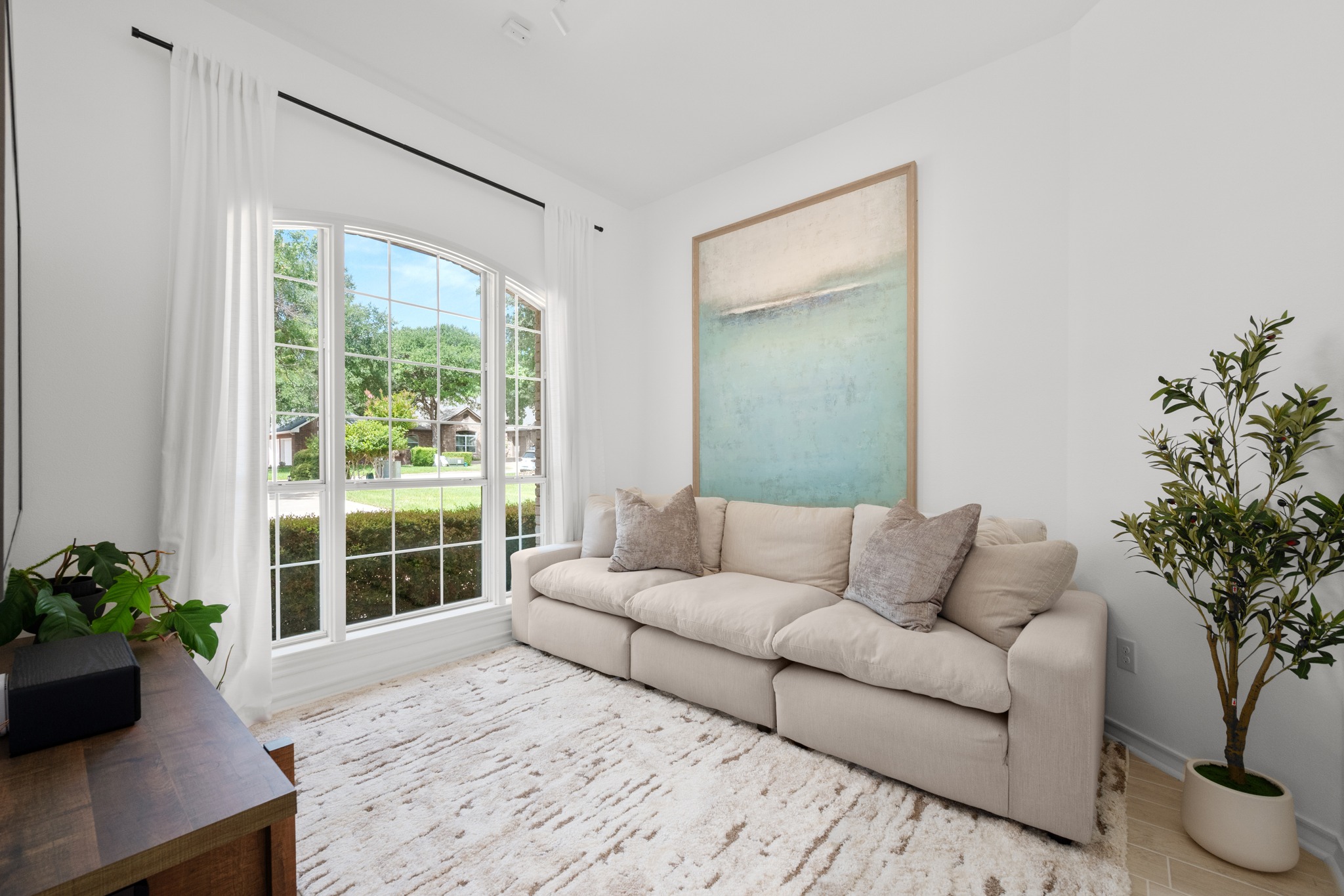30115 Sawgrass Trail Georgetown, TX 78628 - Photo 6 of 37 Natural light streams through expansive windows, illuminating a comfortable and inviting living space.